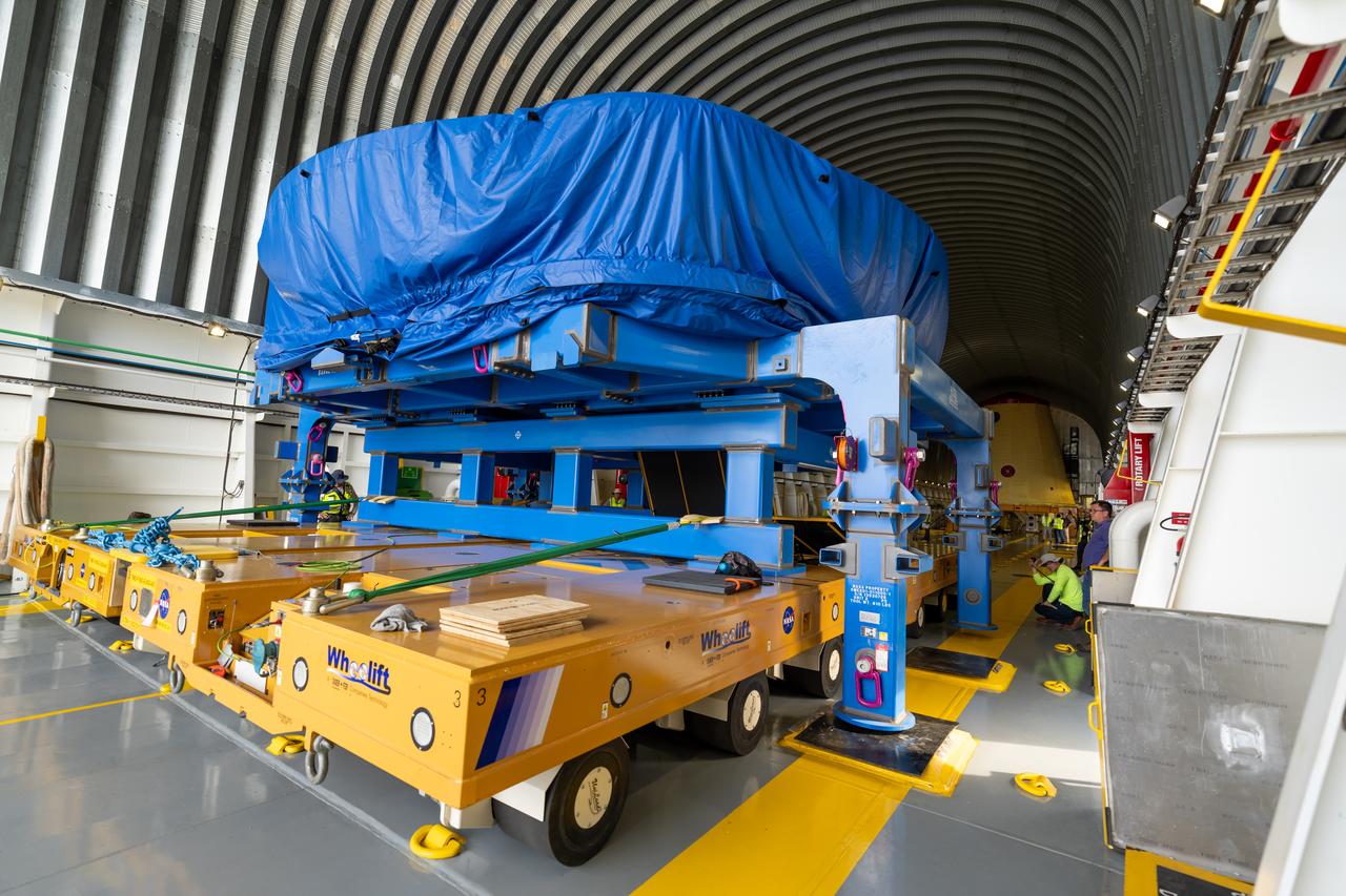 These photos and videos show teams at NASA’s Michoud Assembly Facility in New Orleans preparing, moving, and loading the engine section boat-tail of NASA’s SLS (Space Launch System) rocket for the Artemis III mission for transportation to NASA’s Kennedy Space Center in Florida via the agency’s Pegasus barge. Inside the factory on Aug. 14 prior to the move, technicians covered the spaceflight hardware with a tarp to help protect it on its journey aboard NASA’s Pegasus barge. Crews then rolled out the hardware on Aug. 27 from the factory floor to the barge. Once in Florida, the boat-tail will be integrated with the engine section -- also manufactured at Michoud -- inside Kennedy’s Space Station Processing Facility. The engine section arrived at NASA Kennedy in Dec. 2022. Located at the bottom of the engine section, the aerodynamic boat-tail fairing channels airflow and protects the stage’s four RS-25 engines from extreme temperatures during launch. The engine section is one of five major elements that make up the 212-foot-tall rocket stage. The core stage, along with its four RS-25 engines, produce two million pounds of thrust to help launch NASA’s Orion spacecraft, astronauts, and supplies beyond Earth’s orbit and to the lunar surface for Artemis.